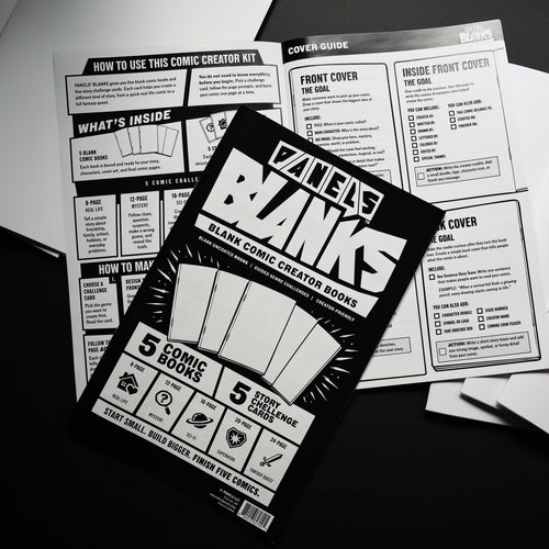 A tabletop flat-lay of the 'PANELS Banks' comic creator board kit, showing the black-and-white instruction booklet in the foreground surrounded by white paper sheets on a dark surface.
