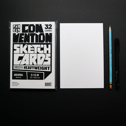 A package of Convection Sketch Cards shown next to a blank white card, a blue pencil, and a black pen on a black background.